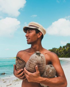 a man standing next to a body of water