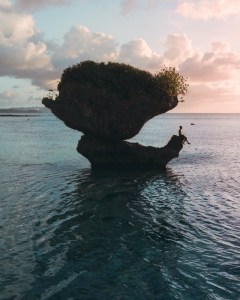 a person standing next to a body of water