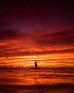 a person with a sunset in the background