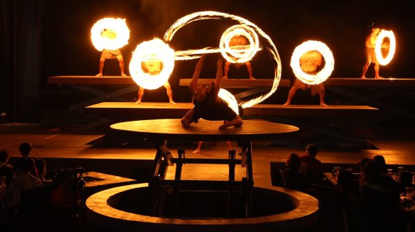 Fire dancers on platforms twirling fire at TaoTao Tasi show in Tumon, Guam