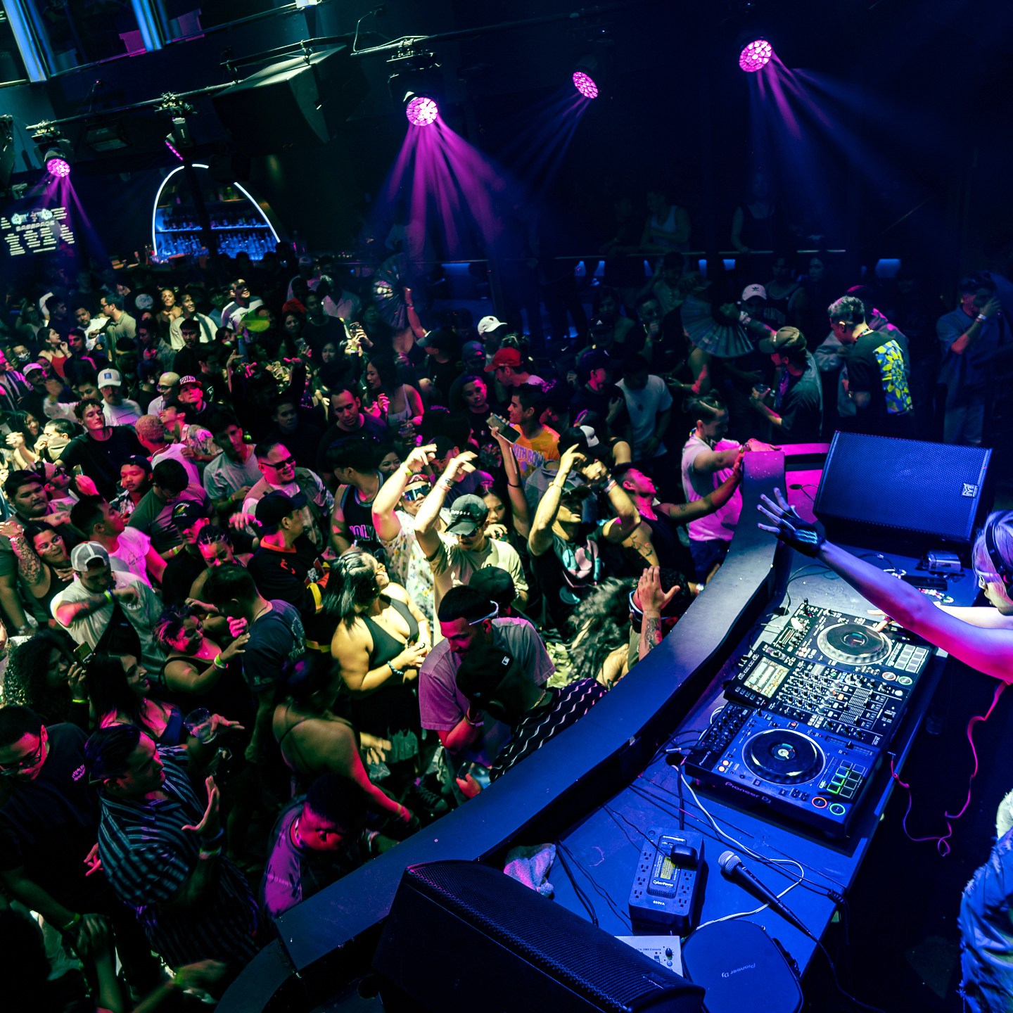 a person sitting on stage with stage lights and an audience