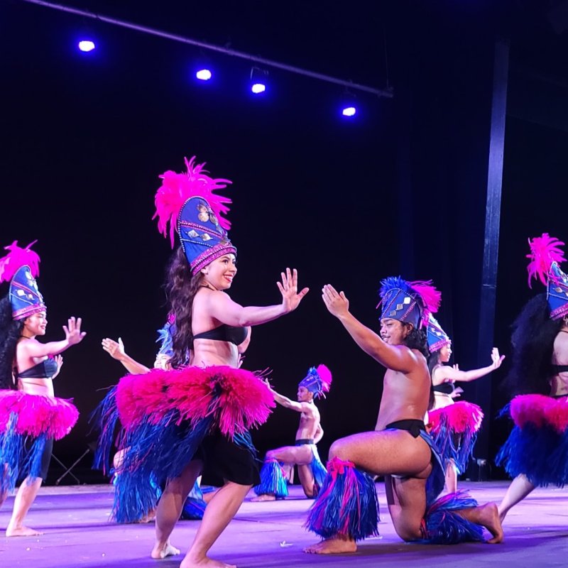 a little girl jumping on a stage