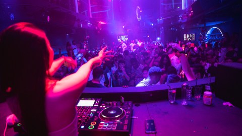 a person standing on a stage playing a video game