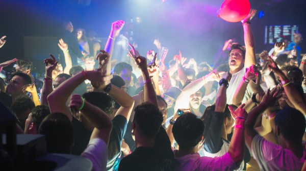 a group of people on a stage in front of a crowd