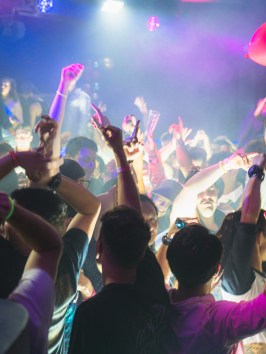 a group of people standing on a stage in front of a crowd