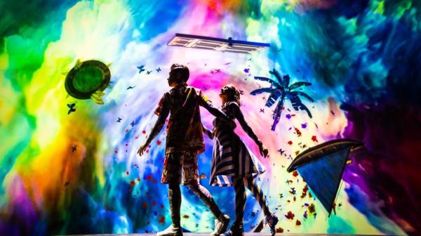 a man on stage with stage lights and an audience