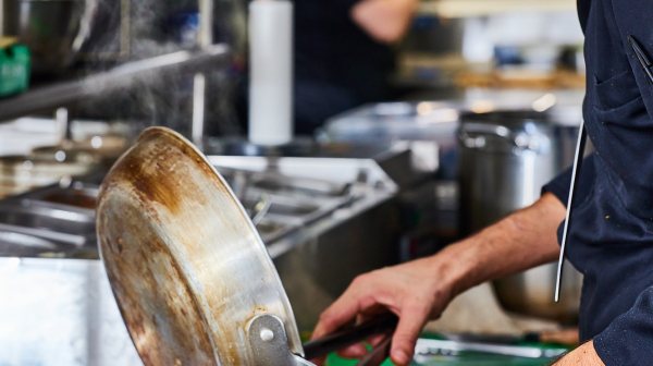 a man preparing food in a bowl