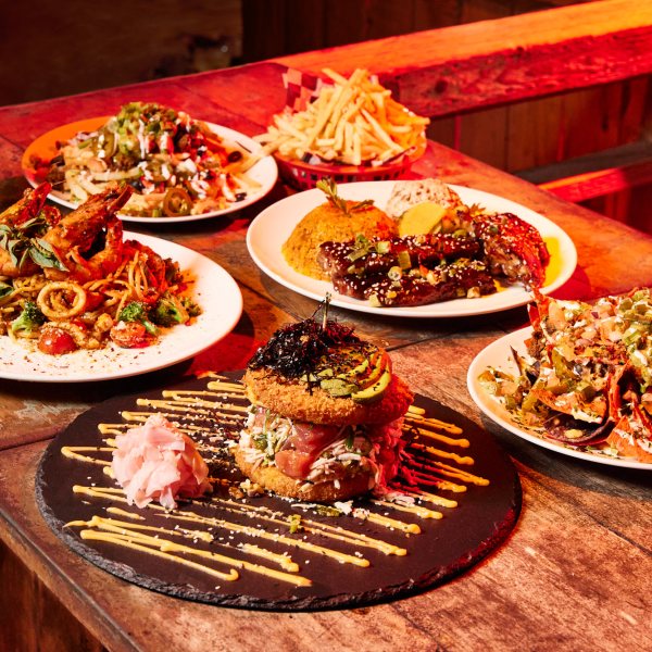a wooden table topped with plates of food on a plate