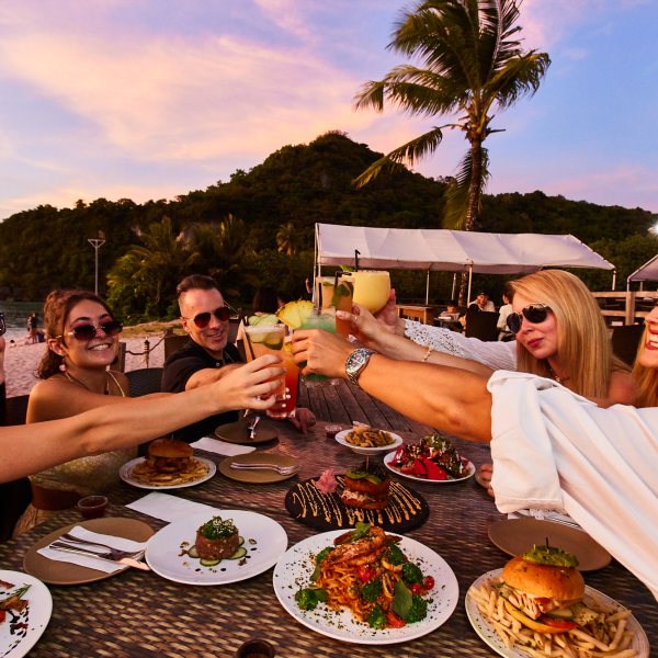 a group of people sitting at a table with a plate of food