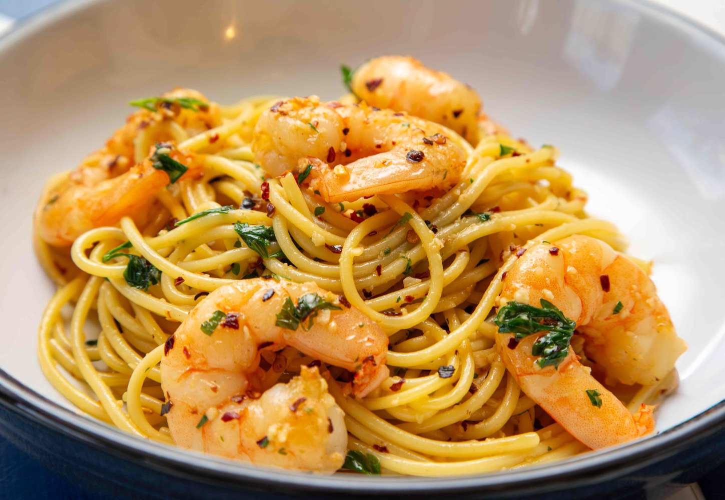 a bowl filled with pasta and broccoli on a plate