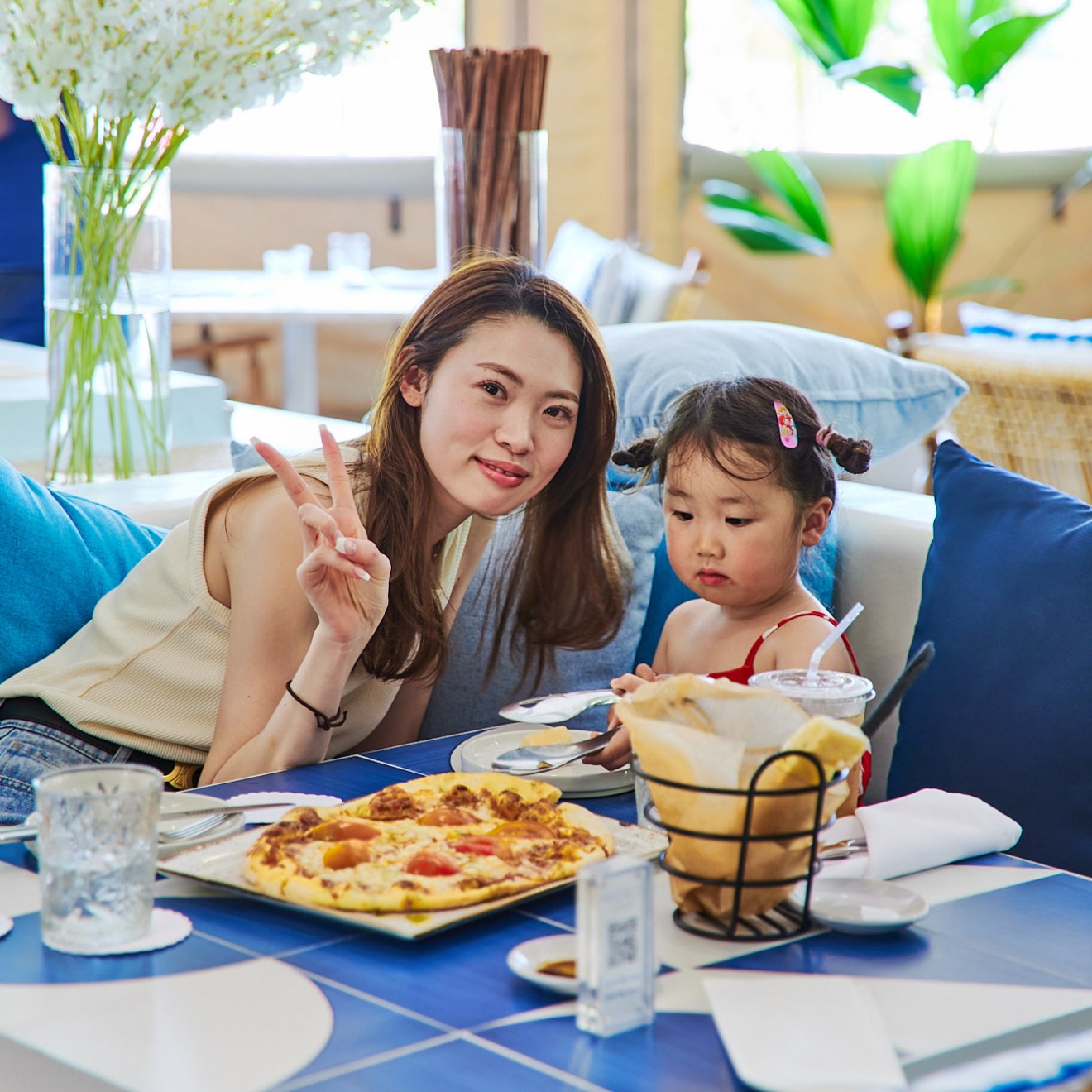 a woman sitting at a table eating food