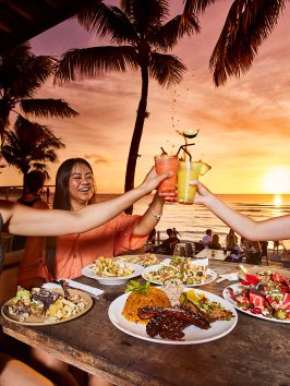 a woman sitting at a table with a plate of food
