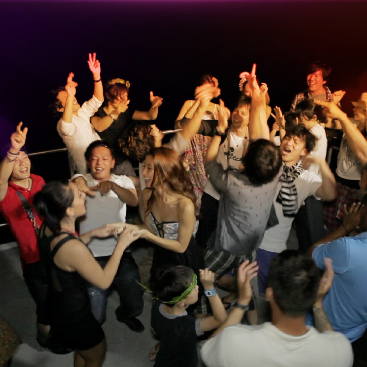 a group of people watching a band on stage in front of a crowd