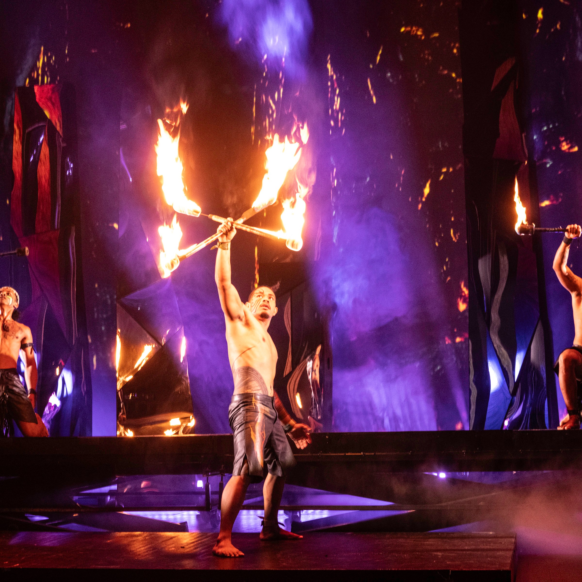 a group of people standing around a fire