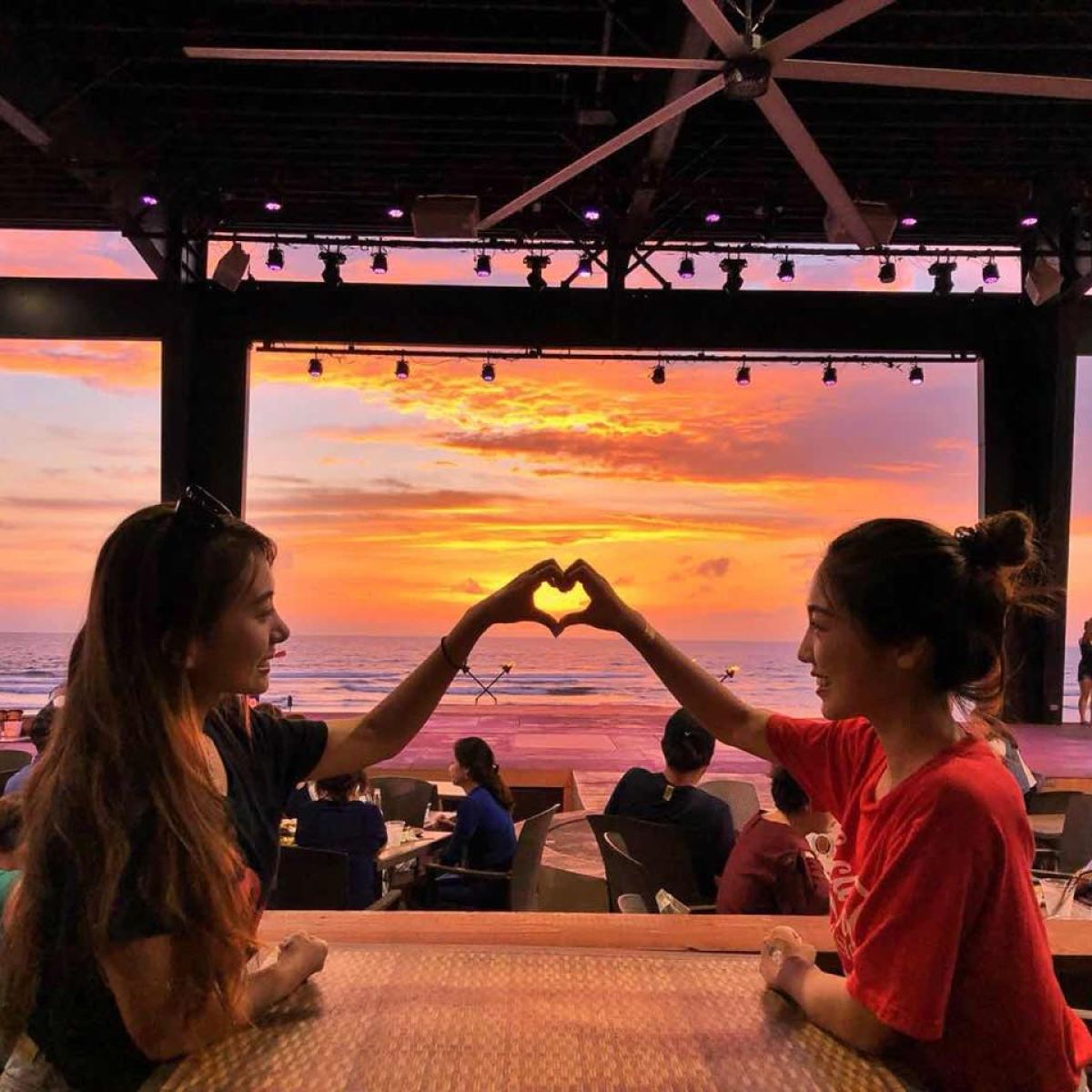 a group of people standing in front of a bridge