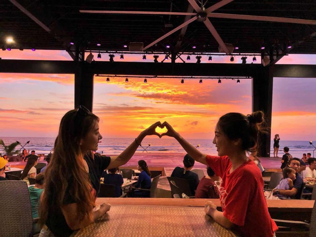 a group of people standing in front of a bridge