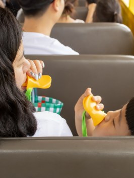 a group of people sitting around a car