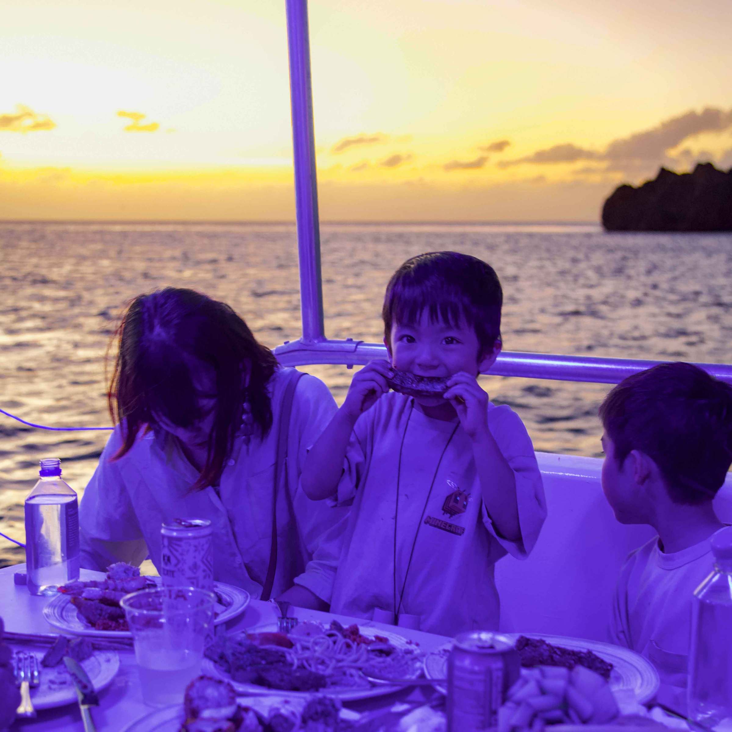 a couple of people that are sitting in front of a body of water