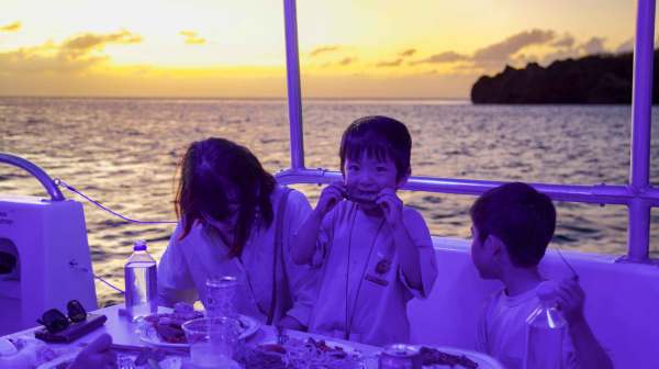a couple of people that are sitting in front of a body of water