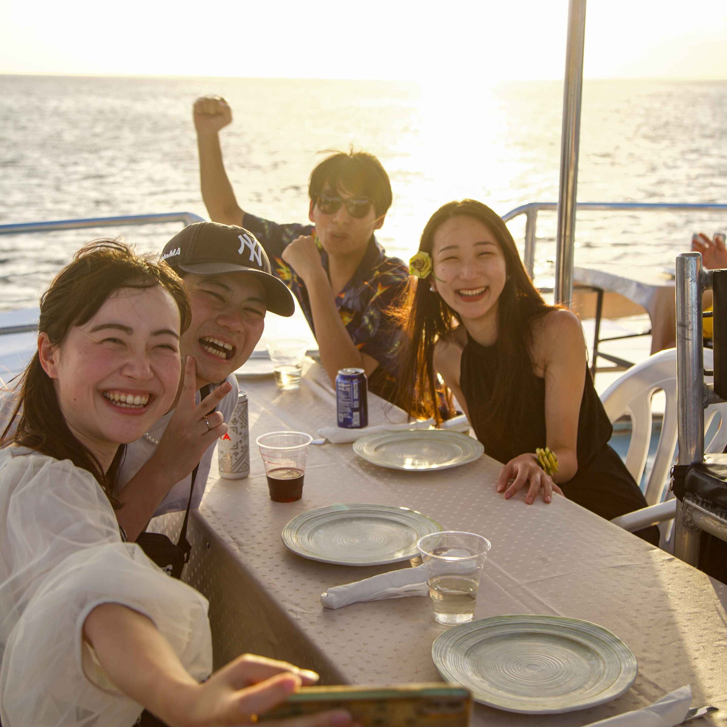 a woman sitting at a table with people in the water