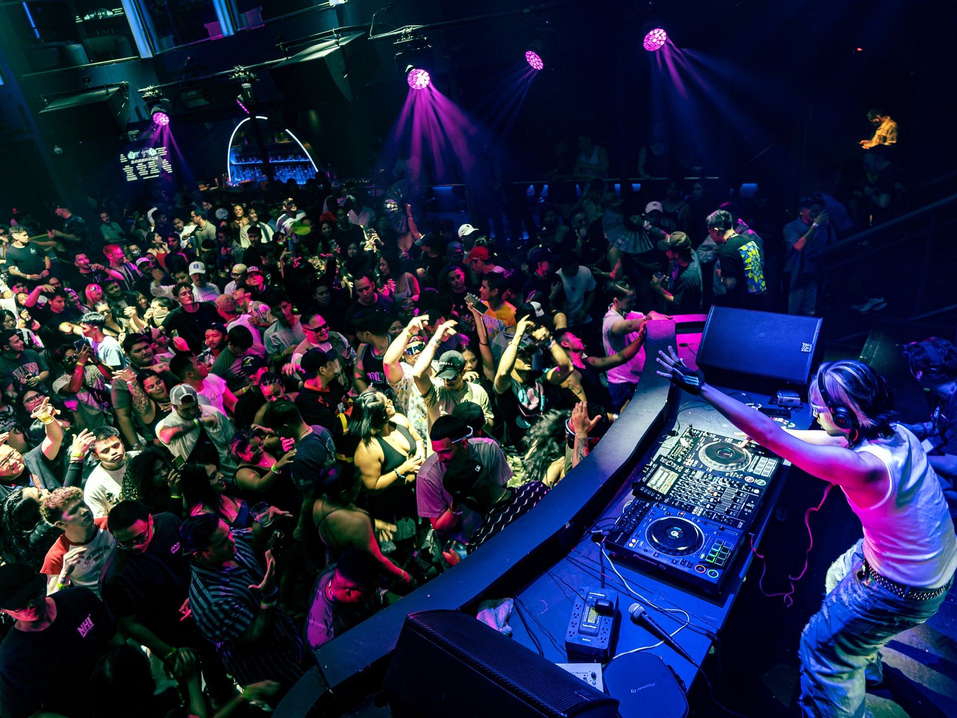a person sitting on stage with stage lights and an audience