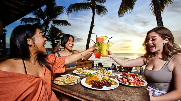 a woman sitting at a table with food
