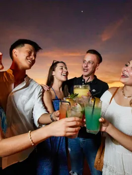 Chris Lowe et al. holding wine glasses