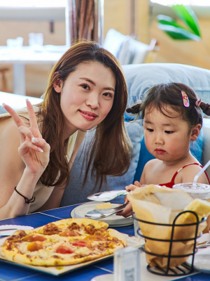 a woman sitting at a table with a plate of food