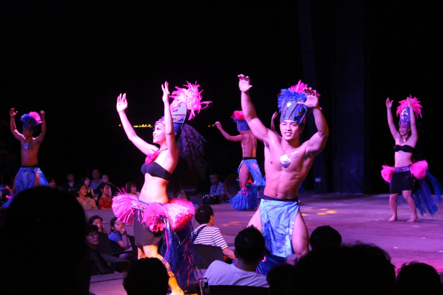 a group of people on a stage in front of a crowd
