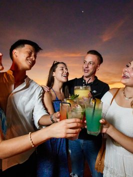 Chris Lowe et al. holding wine glasses