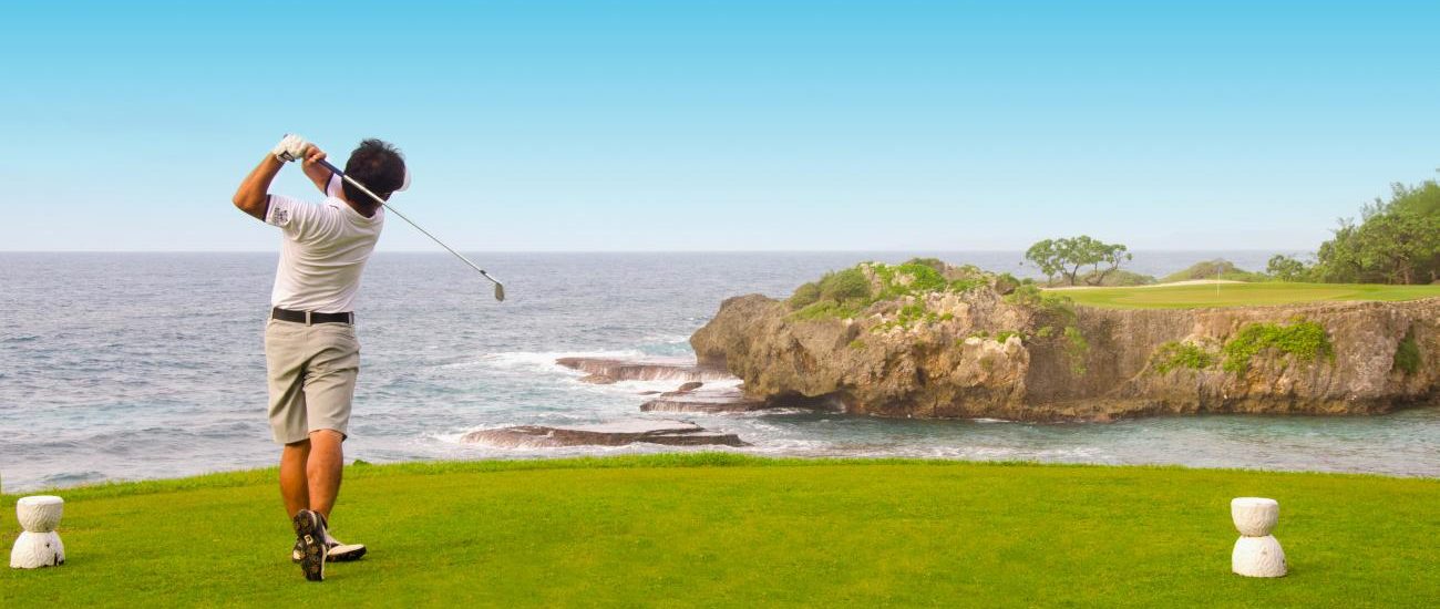 a man flying through the air over a body of water