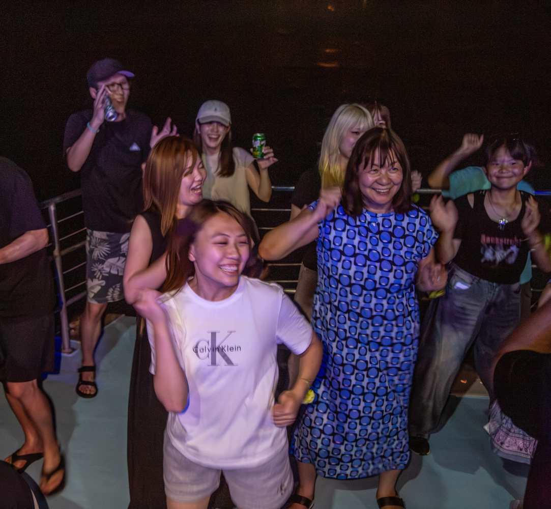 선상 위에서 신나는 음악에 맞춰 댄스 파티를 즐기며 웃고 있는 크루즈 관객들