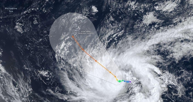 Satellite image of a cyclone with projected path over the Philippine Sea.