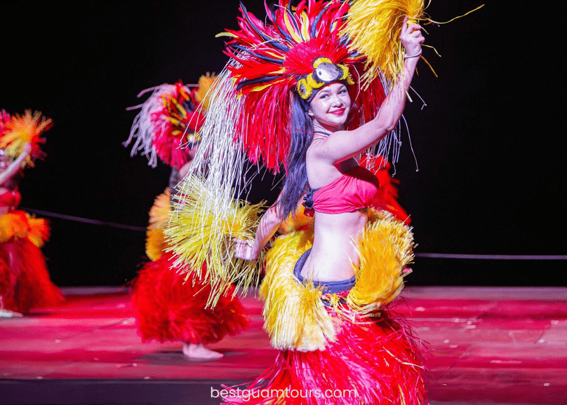 Dancer in red and yellow traditional costume performing on stage.