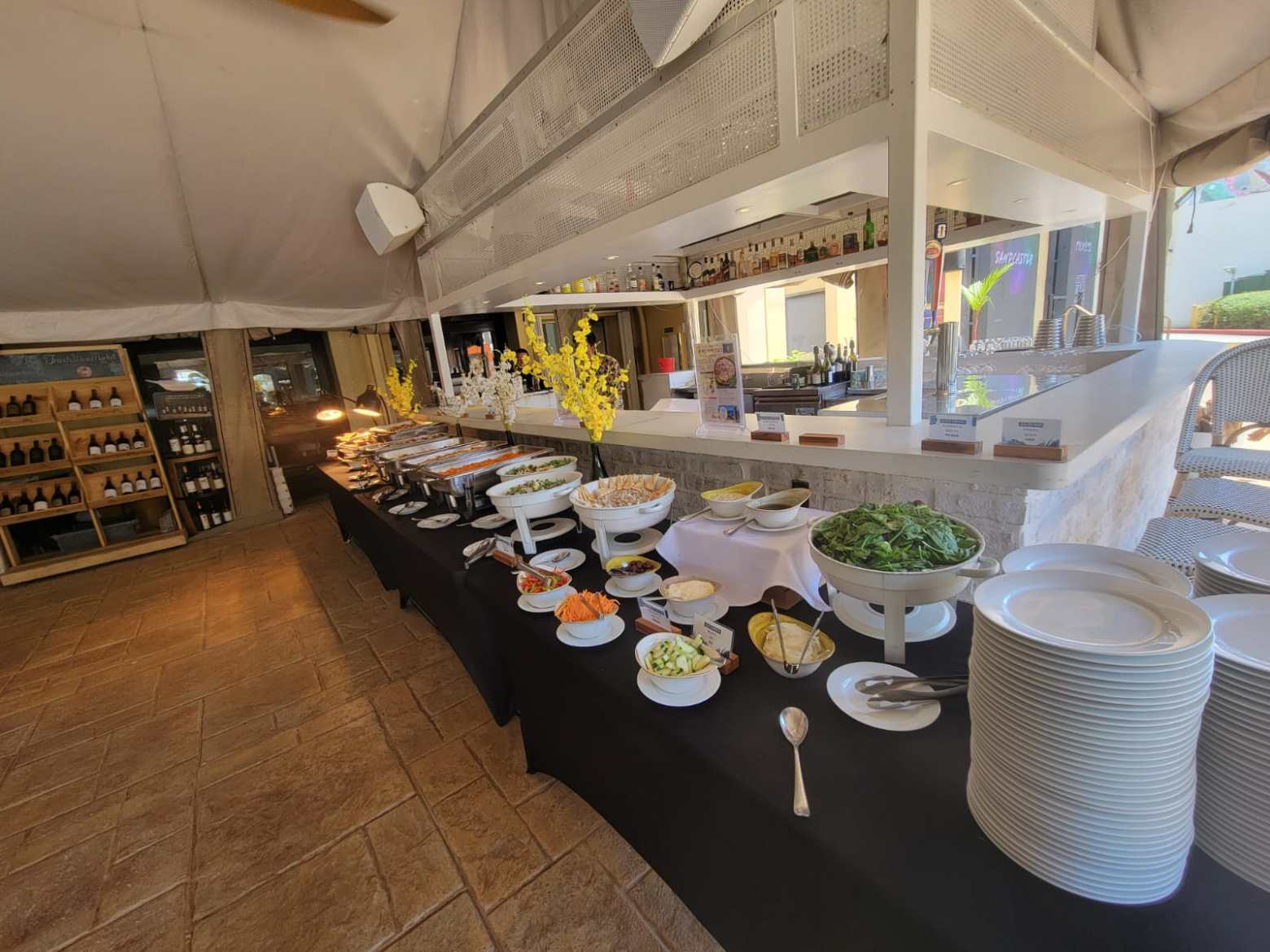 Buffet table with various dishes and plates in a restaurant setting.