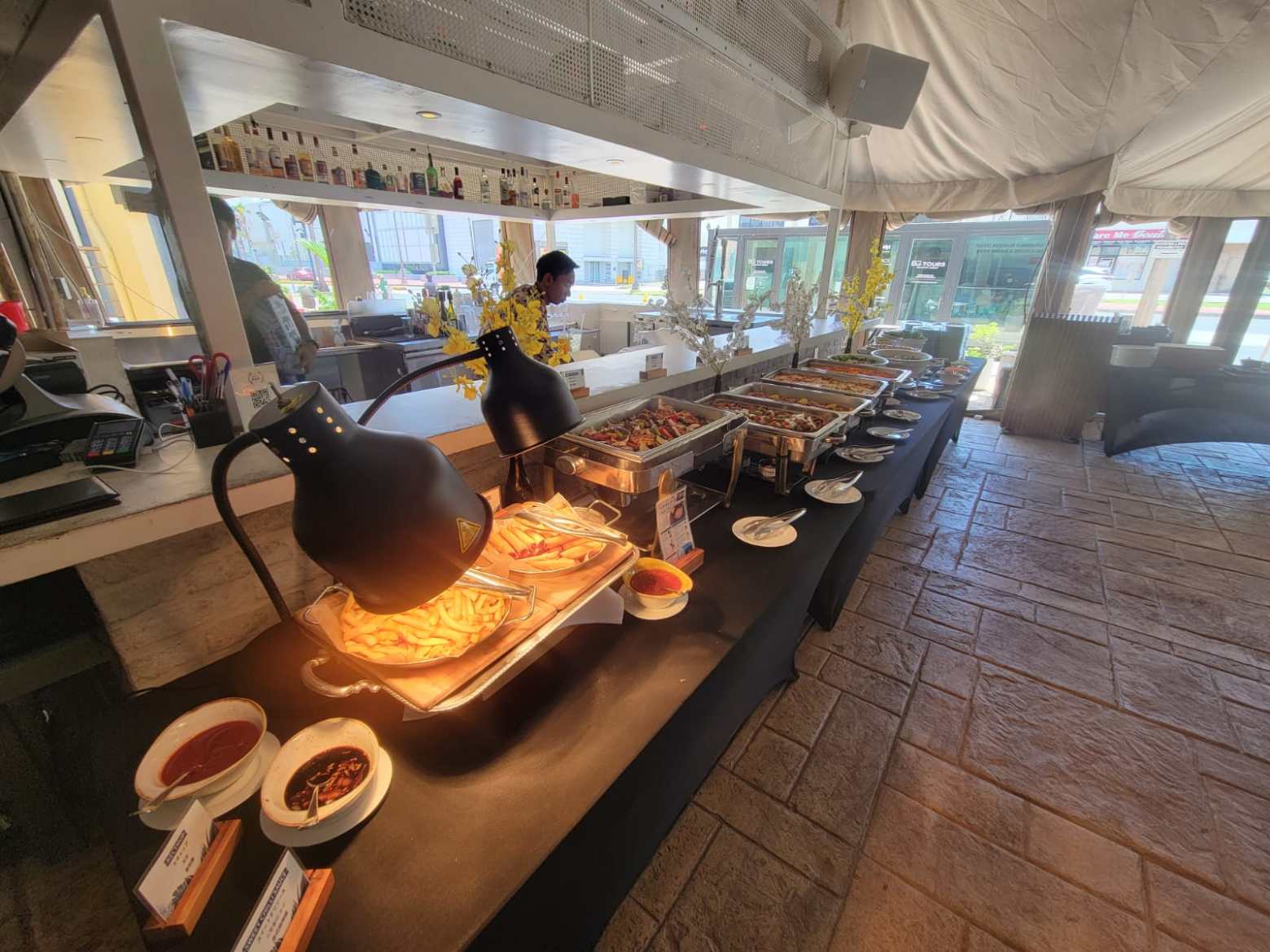 Buffet table with various dishes in a bright indoor setting.